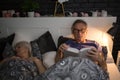 Senior man reading book in bed before sleep Royalty Free Stock Photo