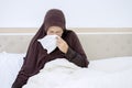 Senior muslim woman wiping her nose with tissue Royalty Free Stock Photo