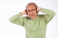 Portrait senior old man with glasses sad covering ears with fingers hands Royalty Free Stock Photo