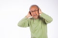 Portrait senior old man with glasses sad covering ears with fingers hands Royalty Free Stock Photo