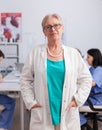 Portrait of senior pediatrician woman standing in front of camera