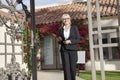 Portrait of a senior real estate agent walking with clipboard in front of house Royalty Free Stock Photo