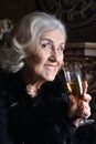 Portrait of senior smiling woman with champagne