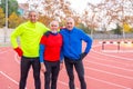 Portrait of senior sportive retired friends in a running track