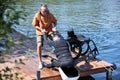 Senior sports instructor assisting man with disability wakeboarding