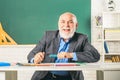 Portrait of senior teacher sitting at desk in classroom. Teacher best friend of learners. School teacher. Study and Royalty Free Stock Photo