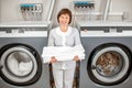 Senior washwoman in the laundry