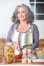 Portrait of a senior woman cooking Royalty Free Stock Photo