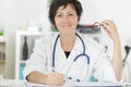 Portrait senior woman doctor smile in medical office Royalty Free Stock Photo