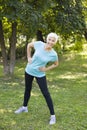 Senior woman doing streching exercise in the park Royalty Free Stock Photo