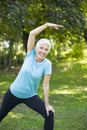 Senior woman doing streching exercise in the park Royalty Free Stock Photo