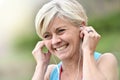 Portrait of senior woman with earphones jogging Royalty Free Stock Photo