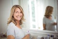 Portrait of senior woman holding toothbrush in bathroom Royalty Free Stock Photo