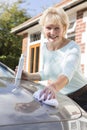 Portrait Of Senior Woman Polishing Car