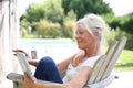 Portrait of senior woman reading book outdoors Royalty Free Stock Photo