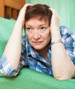 Portrait of senior woman relaxing in couch Royalty Free Stock Photo