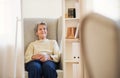 A portrait of a senior woman sitting at home, looking at camera. Copy space. Royalty Free Stock Photo