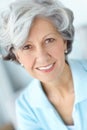 Portrait of a senior woman smiling with great teeth. Happy attractive old female alone at her home. Beautiful elderly Royalty Free Stock Photo