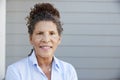 Portrait Of Senior Woman Standing Outside Grey Clapboard House Royalty Free Stock Photo