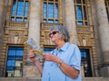 Portrait of a senior woman tourist with map