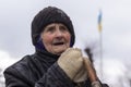 Portrait of a senior woman on the Ukrainian flag background