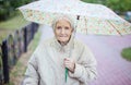 Portrait of senior woman under umbrella
