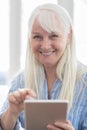 Portrait Of Senior Woman Using Digital Tablet At Home Royalty Free Stock Photo