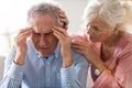 Senior woman consoling her husband at home