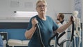 Portrait of senior woman doing physical therapy on stationary bicycle