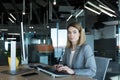 Portrait of a sensible and fair successful woman, businesswoman working in a modern office, at the computer, confident and focused