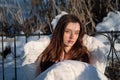Portrait of sensual, attractive, young, sexy, seductive, brunette woman in Bed, outside in the snowy, cold winter nature, on a Royalty Free Stock Photo