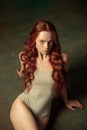 Portrait of sensual beautiful redhead girl with long curly hair. Gorgeous hair and deep green eyes. Concept of beauty Royalty Free Stock Photo