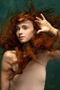 Portrait of sensual beautiful redhead girl with long curly hair. Gorgeous hair and deep green eyes. Concept of beauty Royalty Free Stock Photo