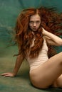 Portrait of sensual beautiful redhead girl with long curly hair. Gorgeous hair and deep green eyes. Concept of beauty Royalty Free Stock Photo