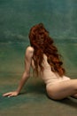 Portrait of sensual beautiful redhead girl with long curly hair. Gorgeous hair and deep green eyes. Concept of beauty Royalty Free Stock Photo