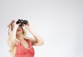 Portrait of Sensual Caucasian Blond Girl Pin-up Style With Binoculars and Looking Upwards. Against White Royalty Free Stock Photo