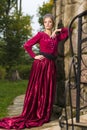 Portrait of Sensual Cute Girl With Tiara Posing with Lifted Hand Near Old Stony Wall Outdoor