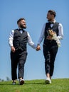 Portrait of sensual gay couple in love on wedding day. Gay grooms walking together on Wedding day. Homosexual gay couple Royalty Free Stock Photo