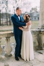 Portrait of sensual just married husband and wife hugging posing in antique ruined palace terrace Royalty Free Stock Photo