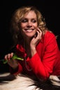 Portrait of sensual lady in red with rose Royalty Free Stock Photo