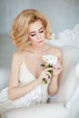 Portrait of the sensual and tender blonde sitting in a whit Royalty Free Stock Photo