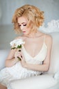 Portrait of the sensual and tender blonde sitting in a whit Royalty Free Stock Photo