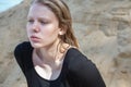 Portrait of young girl in black dress with wet long blonde hair posing outdoors Royalty Free Stock Photo