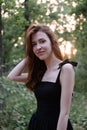 portrait of sensual young woman in a black dress in the forest. freedom, loneliness. nature loving Royalty Free Stock Photo