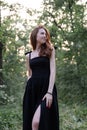 portrait of sensual young woman in a black dress in the forest. freedom, loneliness. nature loving Royalty Free Stock Photo