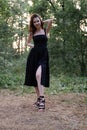 portrait of sensual young woman in a black dress in the forest. freedom, loneliness. nature loving Royalty Free Stock Photo