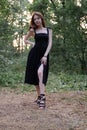 portrait of sensual young woman in a black dress in the forest. freedom, loneliness. nature loving Royalty Free Stock Photo