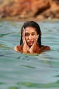 Portrait of serene looking attractive young black female posing in bikini in water. African model posing in the sea Royalty Free Stock Photo