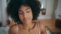 Portrait serene model posing hotel room. Curly hair romantic girl looking away