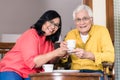 Portrait of serene senior couple enjoying a cup of coffee at hom Royalty Free Stock Photo